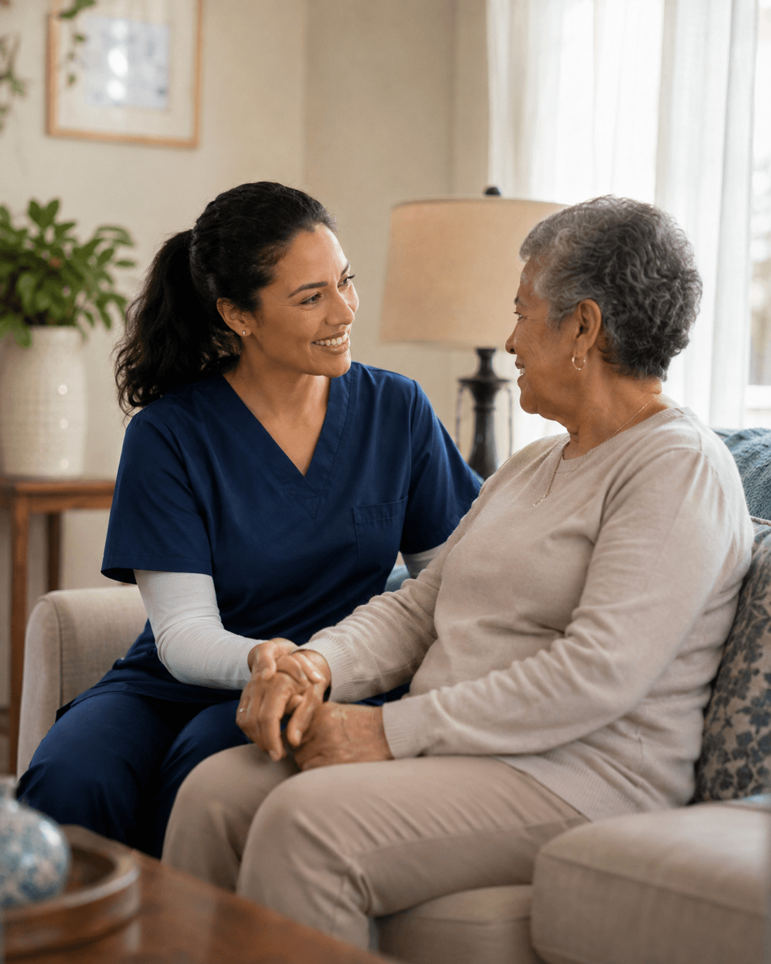 Home health clinician talking with a patient and a family member in a living room.